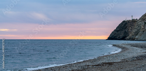 panorama view of La Chucha Beach and the lighthouse of Cabo Sacratif in Andalusia at asunset photo