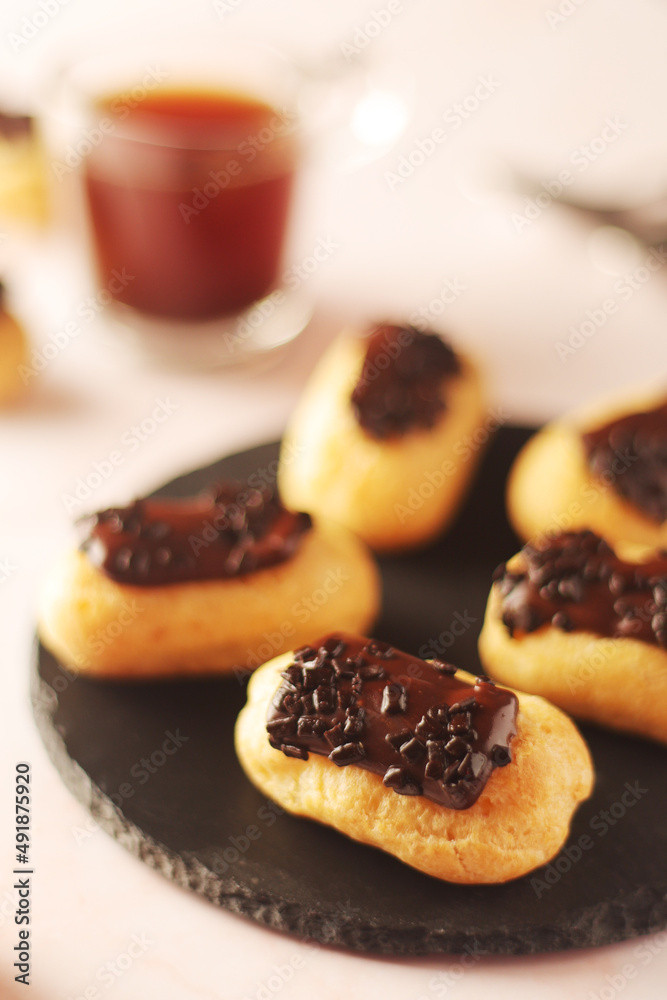 Traditional French dessert - eclairs with a cup of coffee