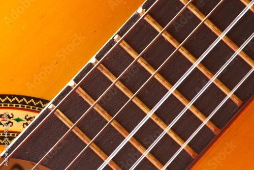 Guitar.Guitar chords.Acoustic guitar.Music.Music background.Image of an acoustic guitar in the dark.Playing music with some friends in the dark.  Classical music. Closet image of an acoustic guitar. photo