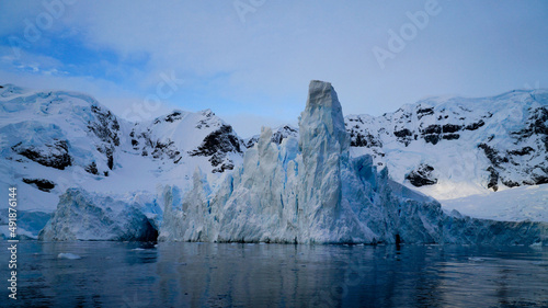 Icebergs in the oceans near Paradise Bay on an overcast day with dark mood in Antarctica. © Christopher