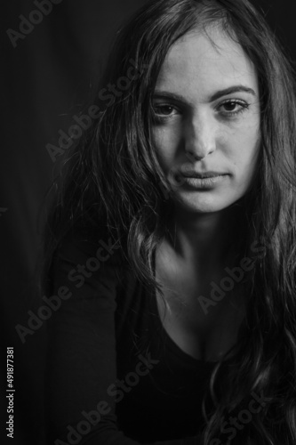 Close up portrait of a beautiful Italian woman with long hair and an intense and seductive gaze 
