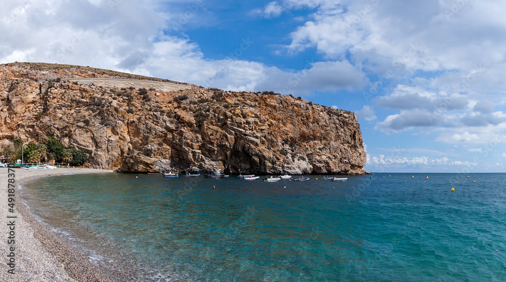 panorama view of Calahonda beach with cliffs and colorful fishing boats