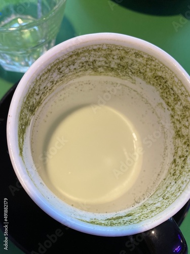 Matcha latte empty cup. Green tea drink with matcha. Matcha latte on the cup bottom