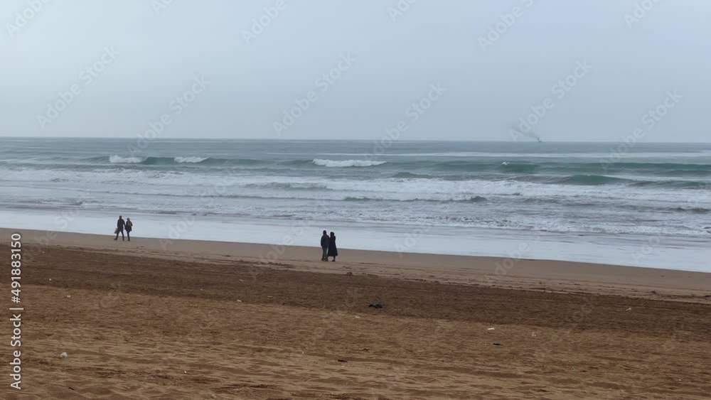Couples walking together in the beach Couples walking together in the beach