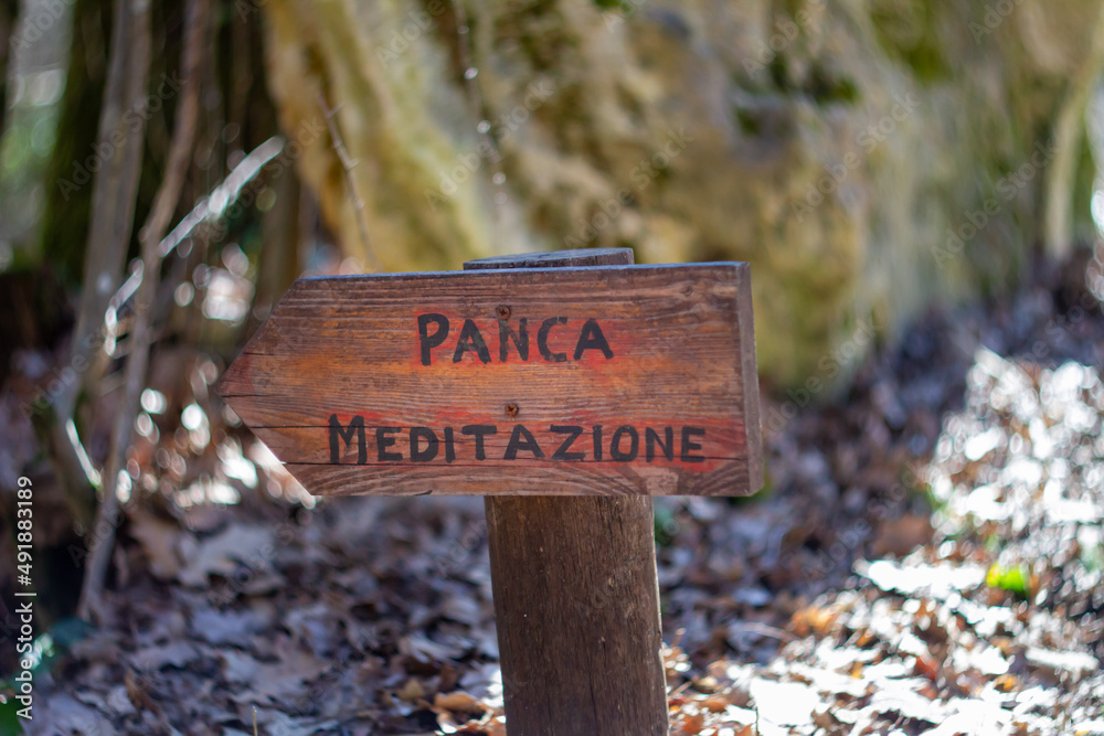 Wood Rustic signs direct to Meditation area Write in Italian language “Panca meditazione” meaning is Meditation bench.Santacittarama “forest sangha”Rieti, Lazio. Monastery, Buddhist Temple
