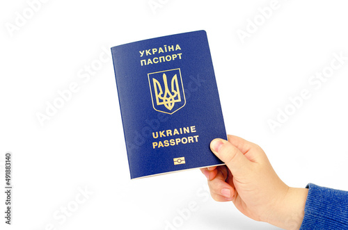 Inscription in Ukrainian Ukraine Passport. Passport of a citizen of Ukraine in a child's hand on a white background, close-up.