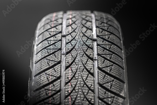 Clean car tyres spinning against dark background