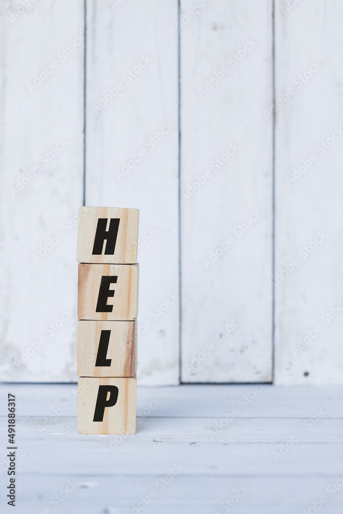 help word or concept on wooden blocks, white wood background help word or concept on wooden blocks, white wood background