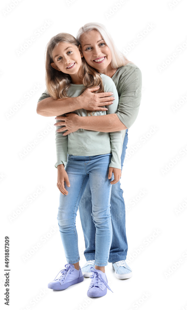 Mature woman hugging her little granddaughter on white background Mature woman hugging her little granddaughter on white background