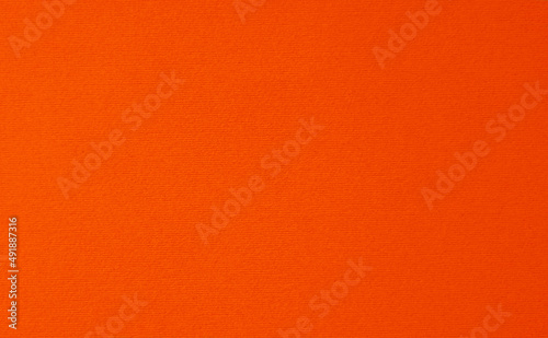 Orange background close up with cardboard paper texture.