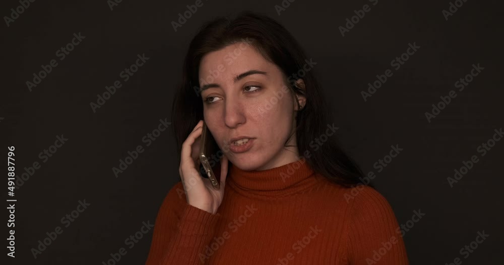 Portrait of middle aged woman using mobile phone and making a call while working from home. Portrait of middle aged woman using mobile phone and making a call while working from home.