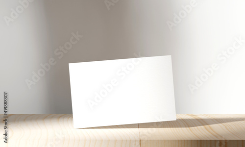 Blank business cards mockup on wooden table. Sunny shadow on wall background. 3D illustration rendering.