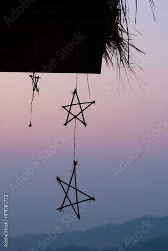 Silhouette hanging star on sunset background