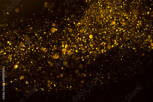 Golden glitter dust shiny sparkling bokeh abstract background