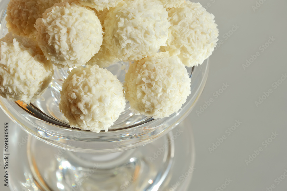 coconut balls. delicious candies with coconut chips. sweet dessert on a light background.
