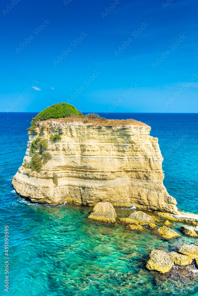 Naklejka premium Beautiful cliffs and sea stacks of Sant'Andrea on the crystal clear waters of Salento, Apulia Italy