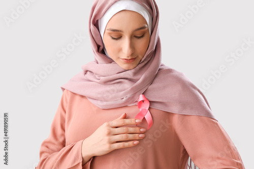 Muslim woman with pink ribb...