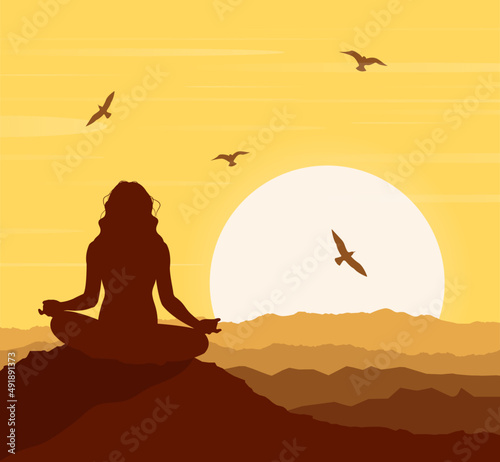 A silhouette of a woman in a lotus pose against a sunset background. Zen, meditation, silhouette of woman practicing yoga lotus position in sunset. Oneness with nature