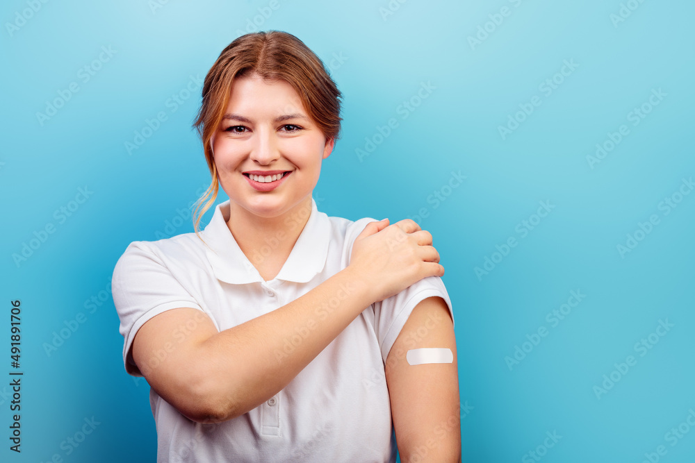 Photo of nice brunette hairstyle lady touch t-shirt, plaster on hand wear white t-shirt isolated on blue color background Photo of nice brunette hairstyle lady touch t-shirt, plaster on hand wear white t-shirt isolated on blue color background