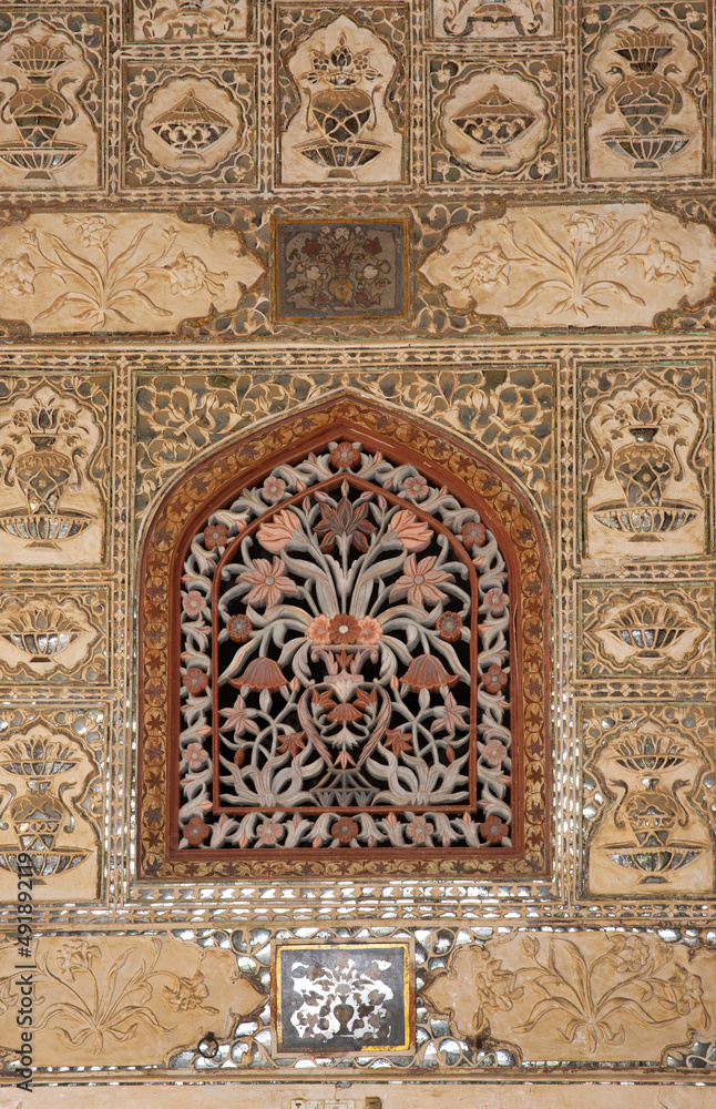 Beautiful design on the wall of  Sheesh Mahal of  ancient Amer fort of Jaipur, India