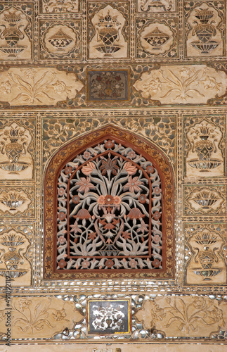 Beautiful design on the wall of Sheesh Mahal of ancient Amer fort of Jaipur, India
