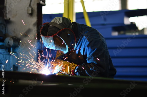 A welder works at a factory