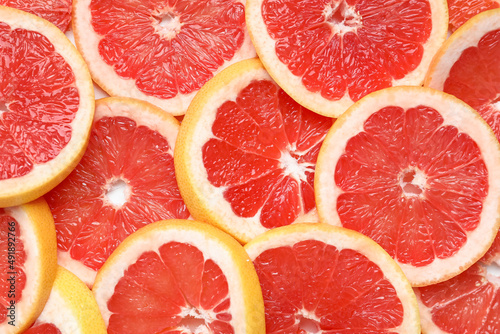 Slices of tasty ripe grapefruit as background