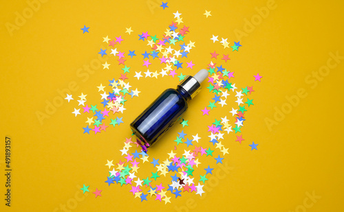 blue glass bottle with a pipette. Container for cosmetics, serum and oil. Mockup skincare product