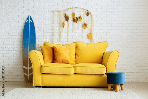 Comfortable sofa, pouf and ...