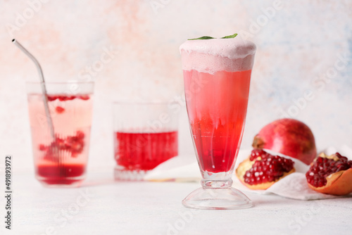 Wallpaper Mural Glasses of tasty pomegranate cocktail on light background Torontodigital.ca