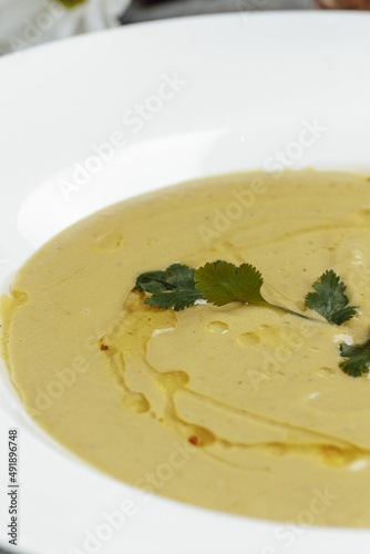 Delicious cream soup with bread on the table photo