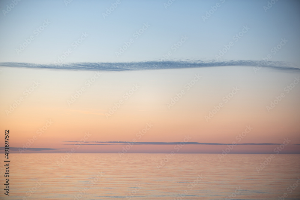 Meditation ocean and sky background. Colorful horizon over the water. Water surface. Abstract cloudscape over the sea, sunrise shot