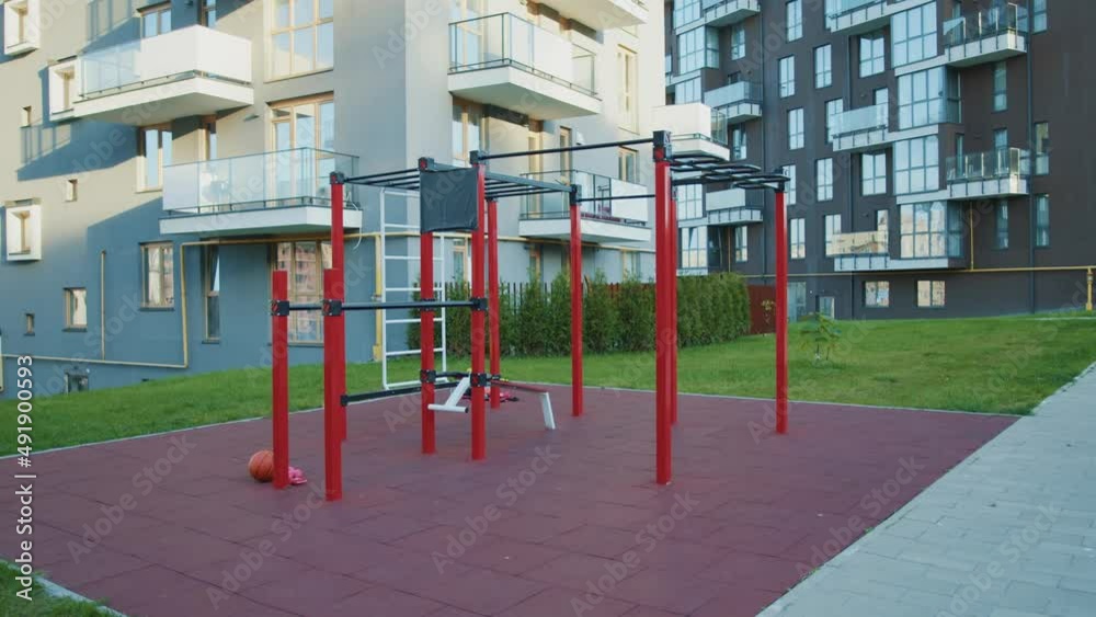 Outdoor sports ground without people. Iron horizontal bar, crossbar, parallel bars. Near building. Close up. Outdoor sports ground without people. Iron horizontal bar, crossbar, parallel bars. Near building. Close up.