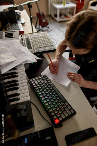 Obraz na płótnie Partial of songwriter writing song at home studio
