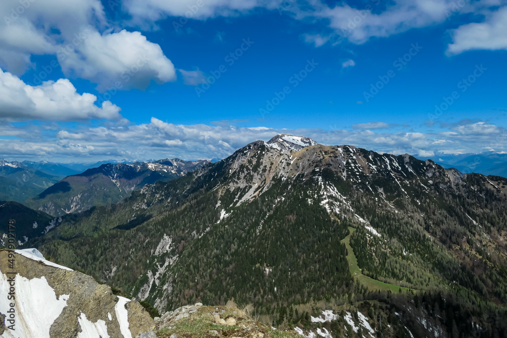 Panoramic view on Mittagskogel (Kepa) and mountain peaks in the Karawanks and Julian Alps, Carinthia, Austria. Borders Austria, Slovenia, Italy. Triglav National Park. Mount Triglav, Mangart