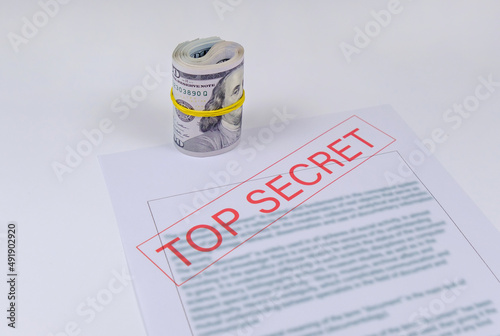 Secret documents and money on white background. Bribery and corruption concepts