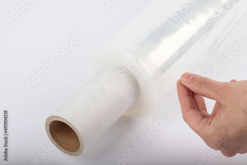 Roll of plastic stretch film with clear wrap. how long the roll of cling film can stretch is shown. It stands in an isolated environment. It is used in the packaging of products.