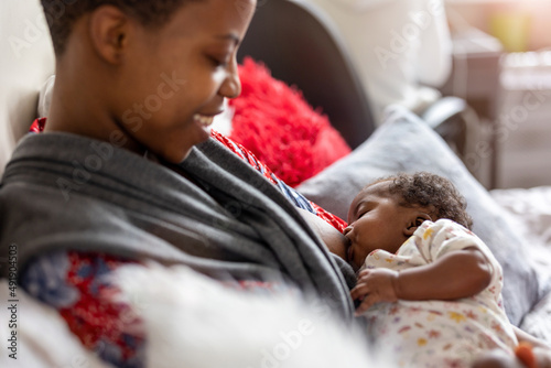 Mother Breastfeeding Baby At Home
 photo
