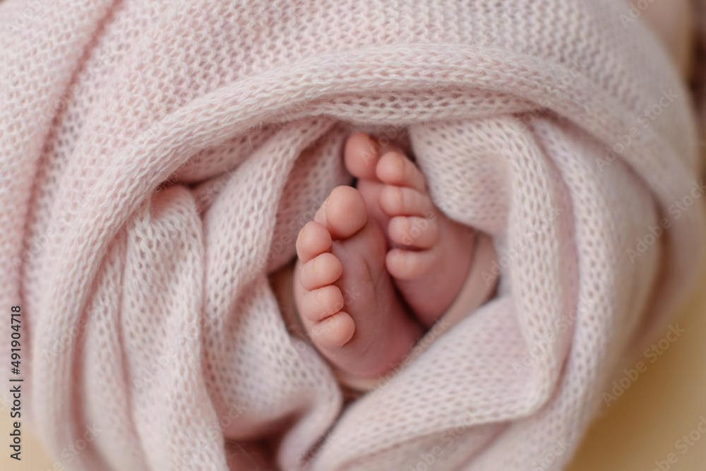 Small beautiful legs of a newborn baby in the first days of life Small beautiful legs of a newborn baby in the first days of life