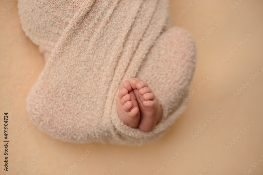 Small beautiful legs of a newborn baby in the first days of life Small beautiful legs of a newborn baby in the first days of life