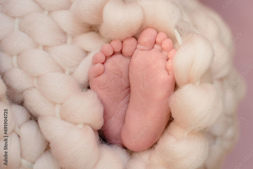 Small beautiful legs of a newborn baby in the first days of life Small beautiful legs of a newborn baby in the first days of life