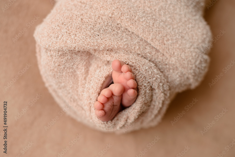 Small beautiful legs of a newborn baby in the first days of life Small beautiful legs of a newborn baby in the first days of life