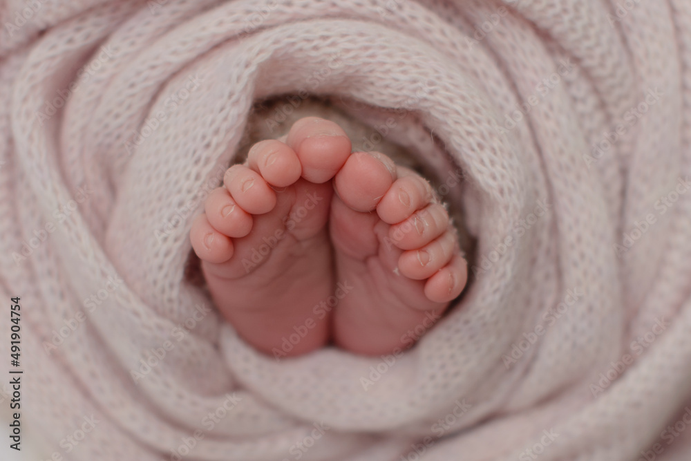 Small beautiful legs of a newborn baby in the first days of life Small beautiful legs of a newborn baby in the first days of life