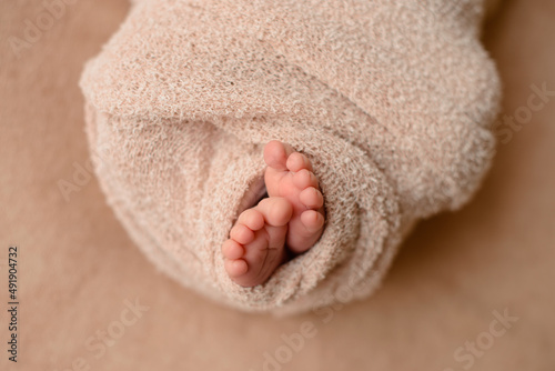 Small beautiful legs of a newborn baby in the first days of life