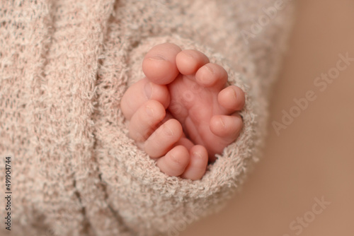 Small beautiful legs of a newborn baby in the first days of life