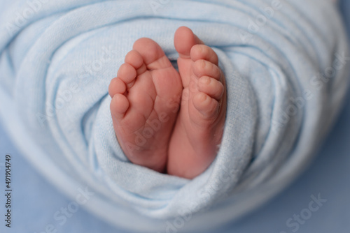 Small beautiful legs of a newborn baby in the first days of life © chernikovatv