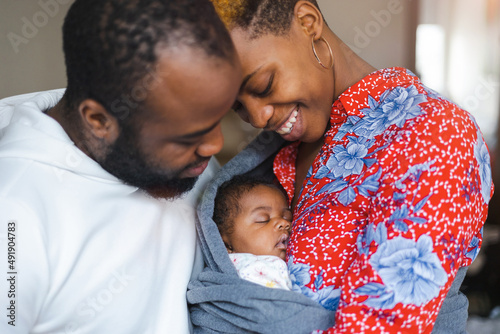 Obraz na plátne Young parents with their baby girl at home