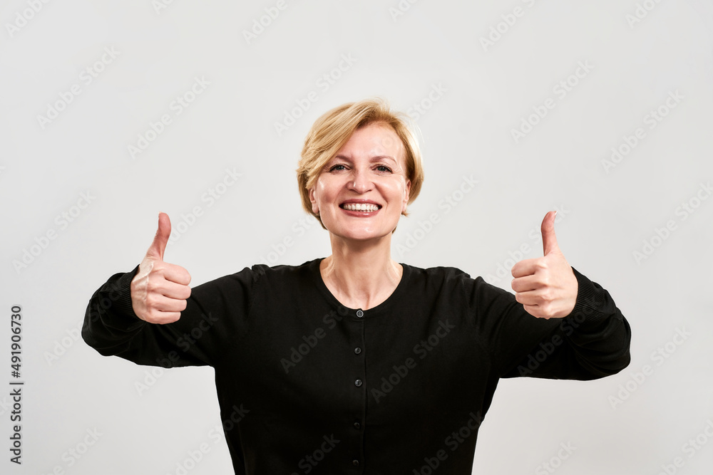 Happy adult caucasian woman show thumbs up gesture Happy adult caucasian woman show thumbs up gesture