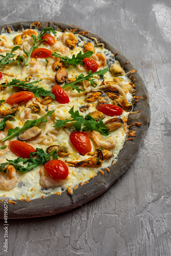 Delicious seafood pizza on light grey table, top view. Space for text