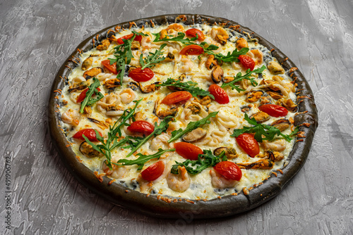 Delicious seafood pizza on light grey table, top view. Space for text